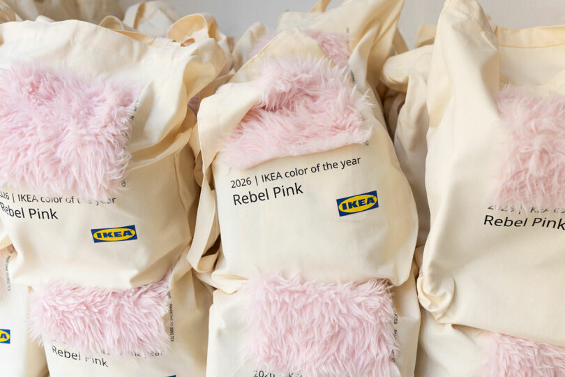 Several cream IKEA tote bags with pink faux fur patches and text reading "2026 IKEA color of the year Rebel Pink" are displayed side by side.